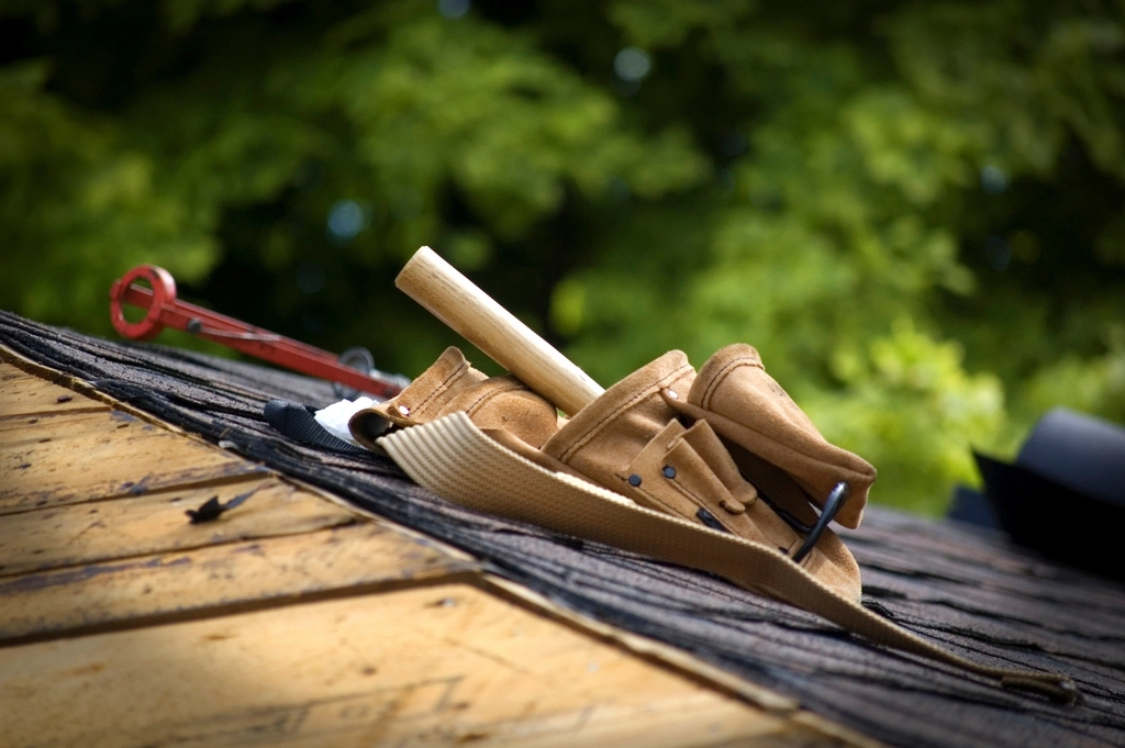 Roofer's tool belt on a shingle roof