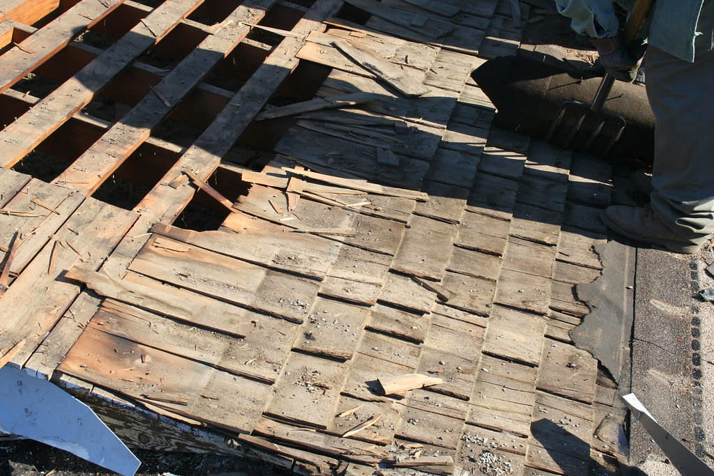 Tear-off in progress on an older roof